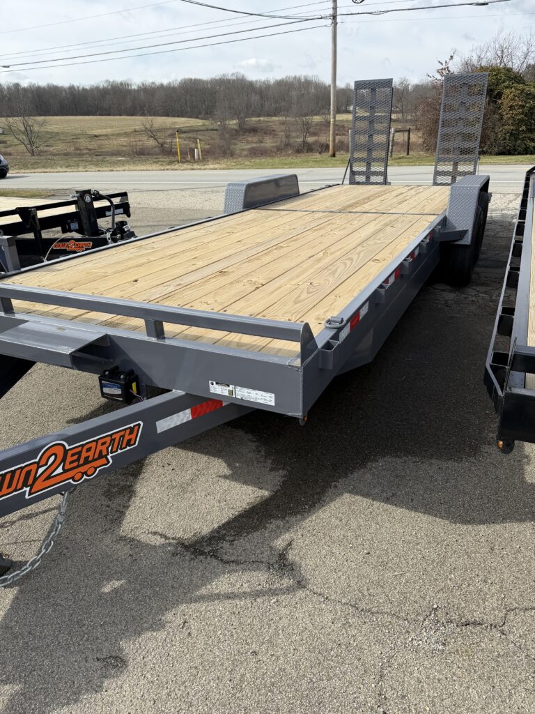 Equipment trailer with a wood deck and ramps